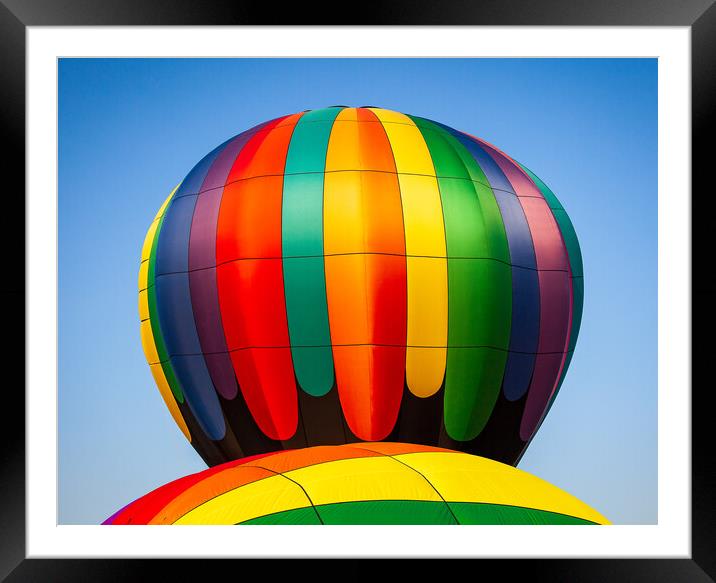 Colorful hot air balloon rising above another with Framed Mounted Print by Steve Heap