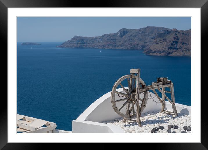 Spinning wheel over ocean on Santorini Framed Mounted Print by Steve Heap