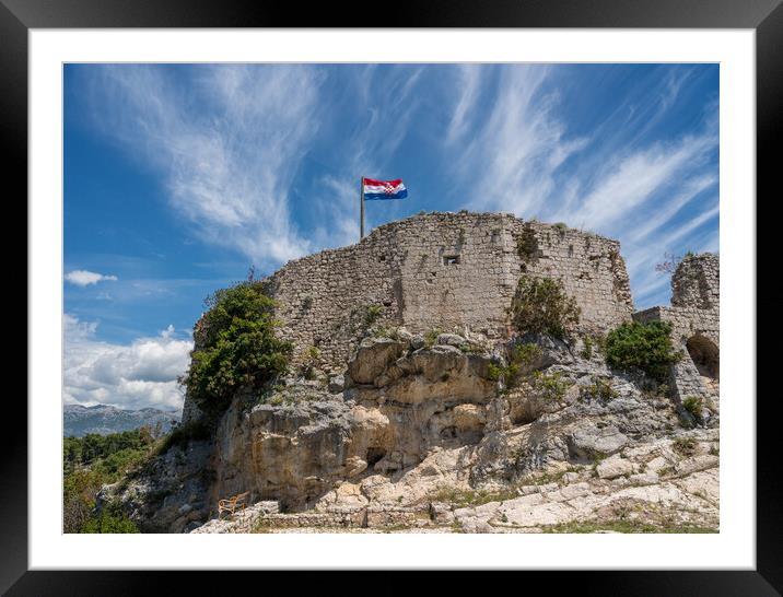 Flag on top of fortress above the Croatian town of Novigrad in I Framed Mounted Print by Steve Heap