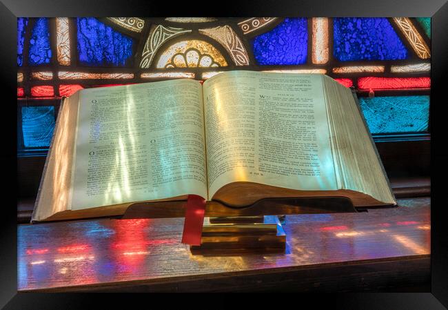 Light from stained glass window falls on open bible in american  Framed Print by Steve Heap