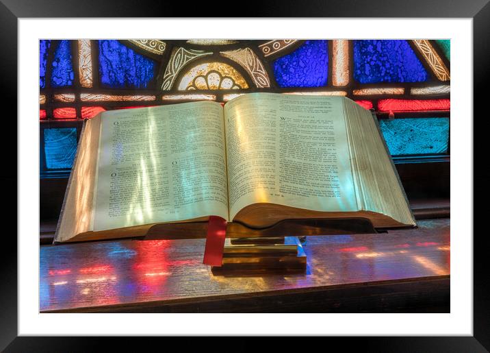 Light from stained glass window falls on open bible in american  Framed Mounted Print by Steve Heap