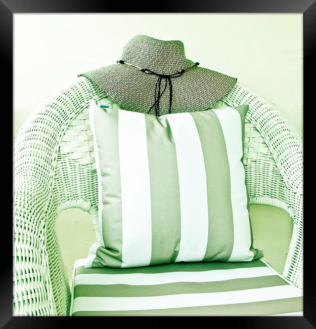 Hat on wicker chair with cushion Framed Print by David Bigwood