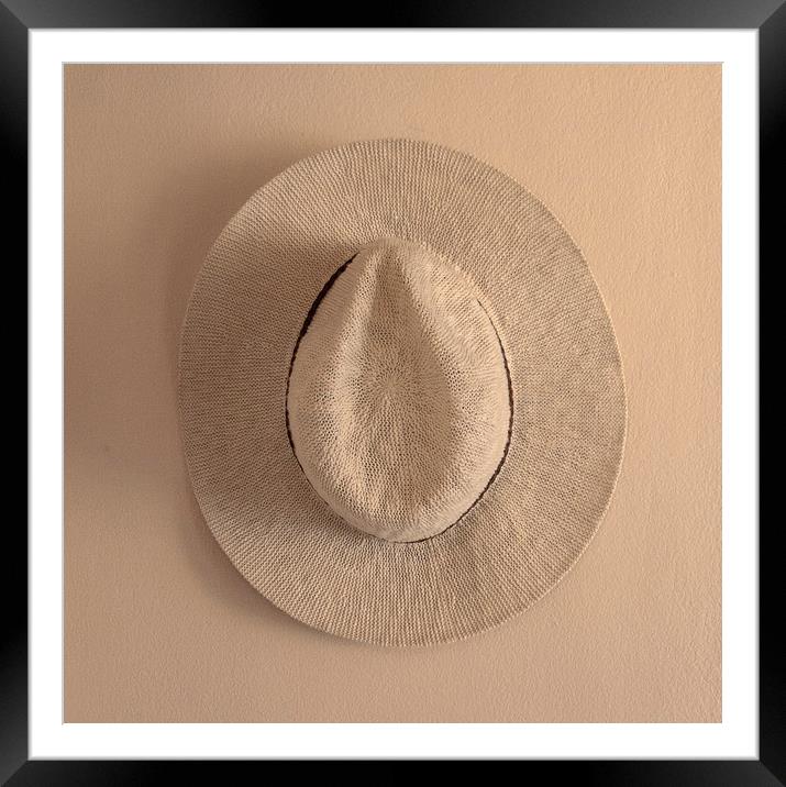 Hat hanging on wall Framed Mounted Print by David Bigwood