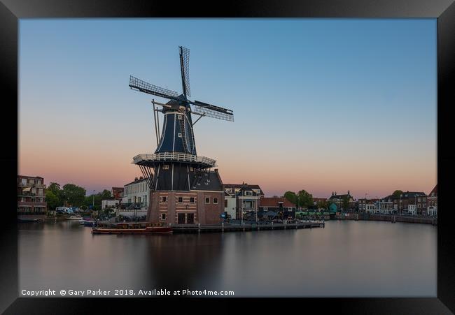 Dutch windmill, in the town of Haarlem, at sunset. Framed Print by Gary Parker