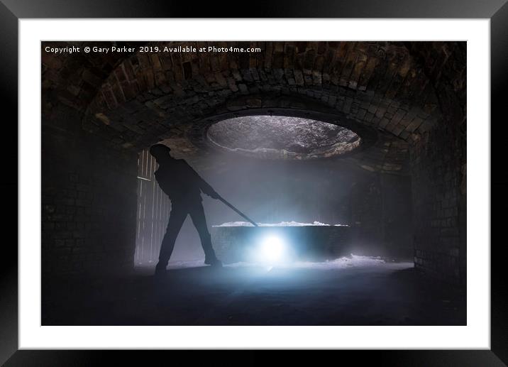 silhouette of iron worker stoking a furnace Framed Mounted Print by Gary Parker