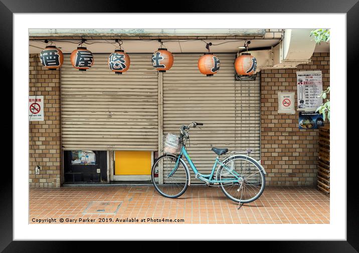 A single bicycle outside a closed shop in Tokyo Framed Mounted Print by Gary Parker