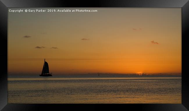 A sailboat , sailing past a tropical sunset	  Framed Print by Gary Parker
