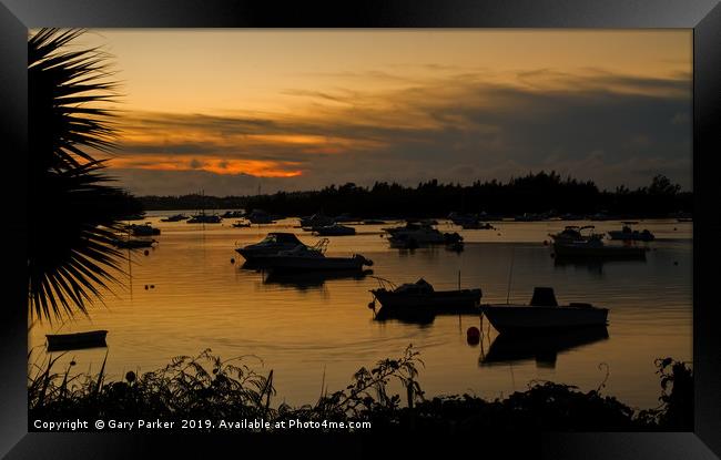 Silhouetted Boats in a Natural Harbour at Sunset Framed Print by Gary Parker