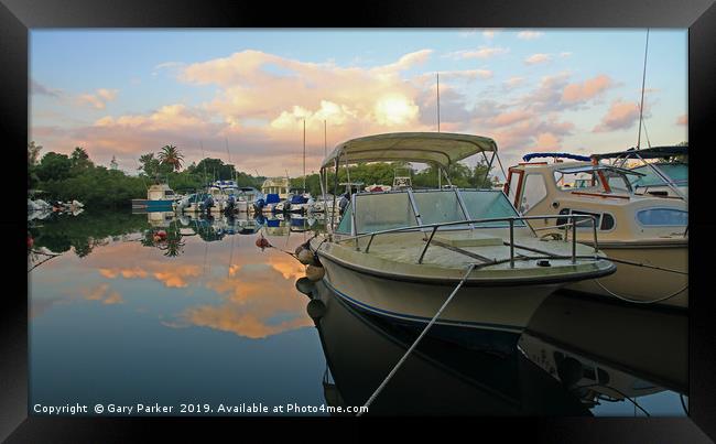 Boats moored in a natural harbour Framed Print by Gary Parker
