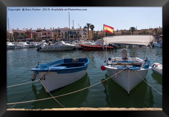 Small fishing boats moored in a Spanish harbour Framed Print by Gary Parker