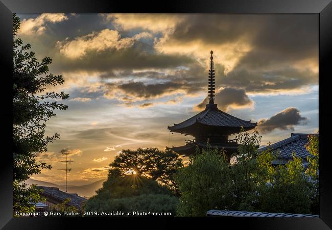 A Japanese pagoda, in Kyoto, framed by a sunset Framed Print by Gary Parker