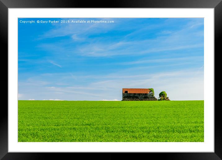 Abandoned farm building, standing in a green field Framed Mounted Print by Gary Parker