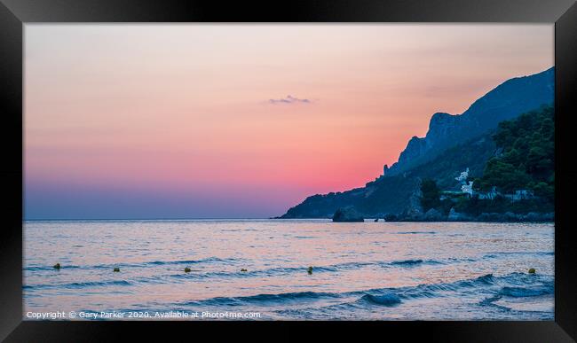 Sunset over a beach in Corfu, Greece	 Framed Print by Gary Parker