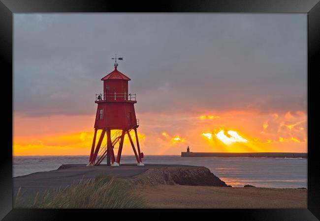 Radiant Sunrise over Red Herd Groyne Lighthouse Framed Print by Rob Cole