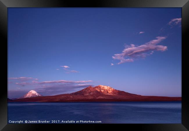 Twilight Over Lake Chungara and Volcanos Chile Framed Print by James Brunker