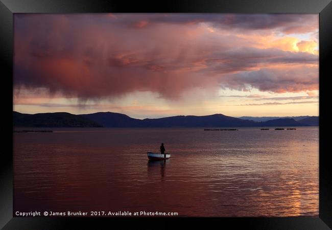 Stormy Sunset and Fisherman on Lake Titicaca Framed Print by James Brunker