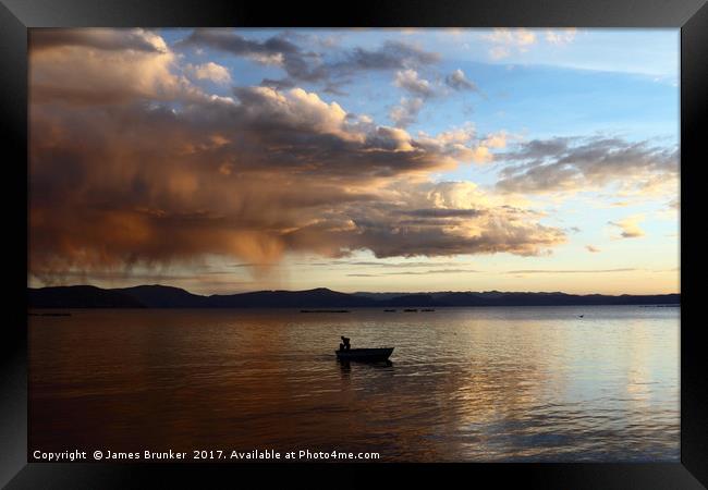 Dramatic Clouds and Fisherman on Lake Titicaca Framed Print by James Brunker