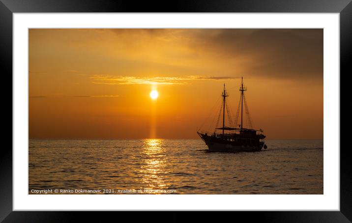 Sailing boat at sunset Framed Mounted Print by Ranko Dokmanovic
