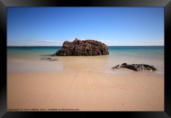 Sandy Beach with turquoise sea water with rocks. l Framed Print by nuno valadas