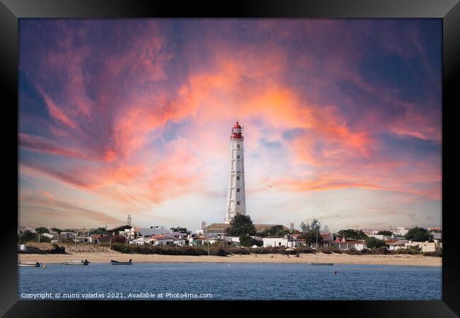Beautiful lighthouse overlooking the ocean at suns Framed Print by nuno valadas