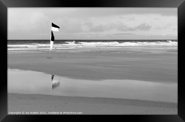 Yellow and red beach safety flag on a Cornish beach in black and Framed Print by Joy Walker