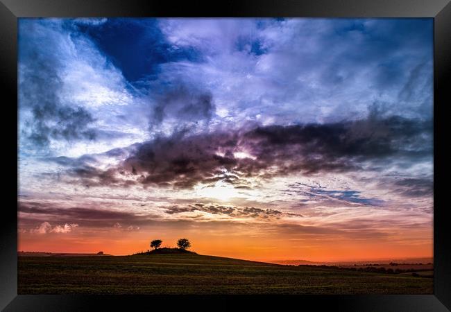 Colourful cloudy sky sunset behind a small hill Framed Print by André Jorge