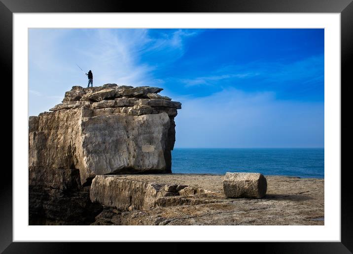 Fisherman casting a rod on the coast cliff rock Framed Mounted Print by André Jorge