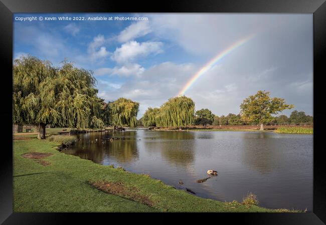 Rainbow over ponds Framed Print by Kevin White