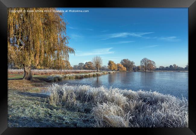 Icy December view with pond and weeping willow tree Framed Print by Kevin White