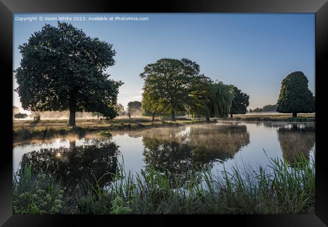 Atmospheric misty morning walk around Bushy Park ponds Framed Print by Kevin White