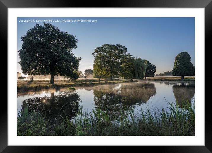Atmospheric misty morning walk around Bushy Park ponds Framed Mounted Print by Kevin White