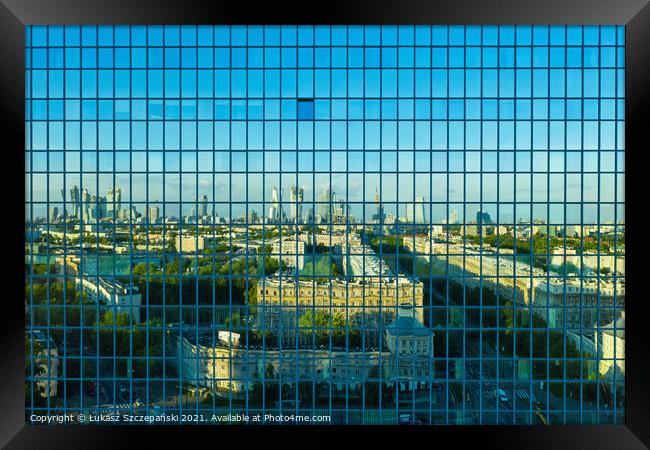 City reflecting in office building Framed Print by Łukasz Szczepański