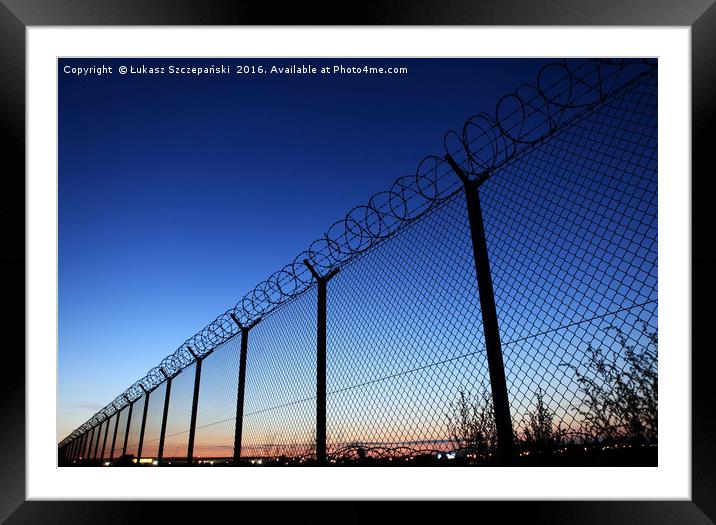 Restricted area fence against dark blue sky Framed Mounted Print by Łukasz Szczepański