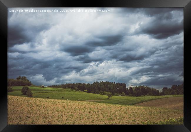 Stormy cloudscape over fields and pasture  Framed Print by Łukasz Szczepański