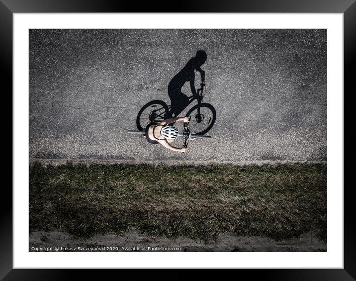 Cyclist on the road, top down image of shadow on t Framed Mounted Print by Łukasz Szczepański