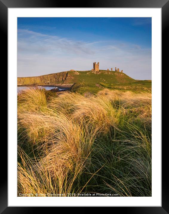 Golden light at Dunstanburgh Castle Framed Mounted Print by Gary Clarricoates