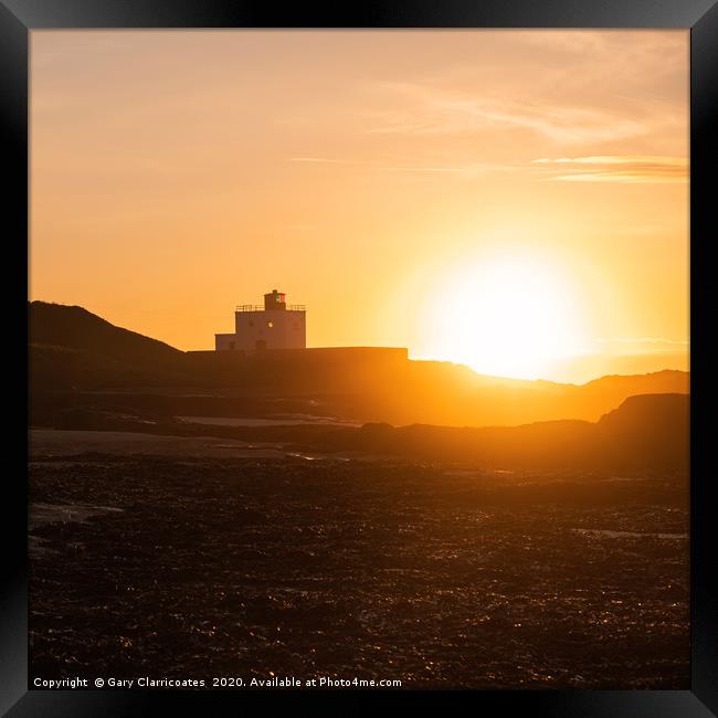 Falling Sun at the Lighthouse Framed Print by Gary Clarricoates