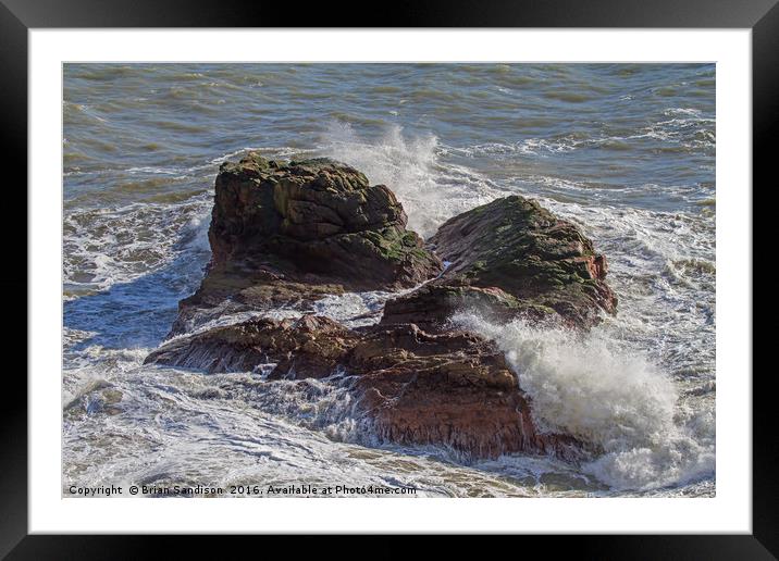 A Heavy Sea smashes the exposed rocks Framed Mounted Print by Brian Sandison