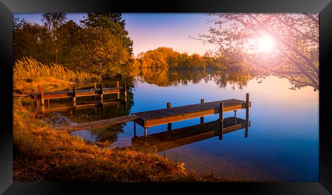 Wooden Jetties on a Becalmed Lake at Sunset Framed Print by Alan Hill