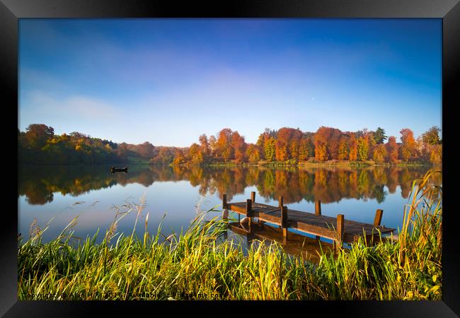 Still waters of a lake in autumn Framed Print by Alan Hill