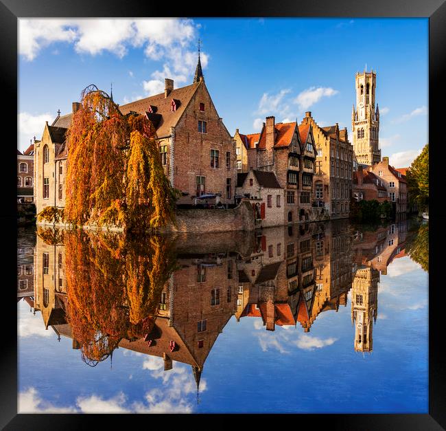 Canals and Buildings of Bruges in Belgium in autumn Framed Print by Alan Hill