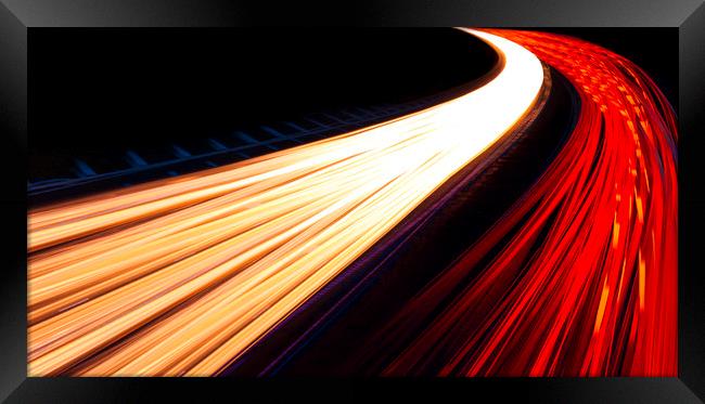 Light trails caused by multiple car headlights and tail lights Framed Print by Alan Hill