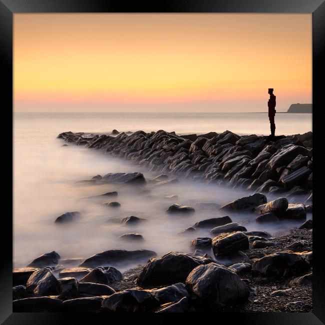 Lone figure stands looking out to sea Framed Print by Alan Hill