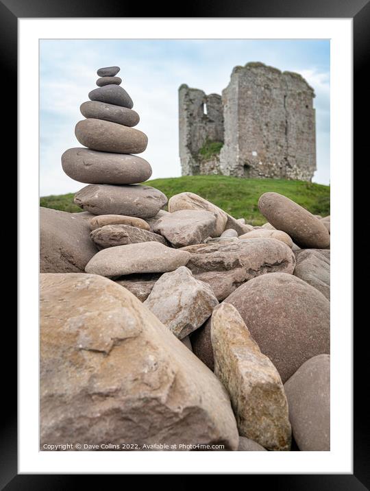 A small rocky cairn on the rocky sea wall at Minard Beach with the remains of Minard Castle defocused in the back, County Kerry, Ireland Framed Mounted Print by Dave Collins