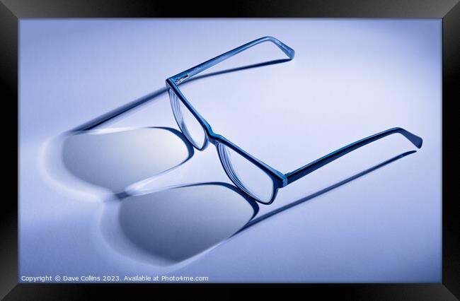 Artistic blue toned pair of blue glasses with shadows Framed Print by Dave Collins