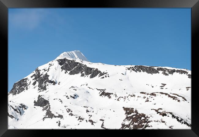 Sun and shadows on a snow covered mountain, Whittier, Alaska, USA Framed Print by Dave Collins