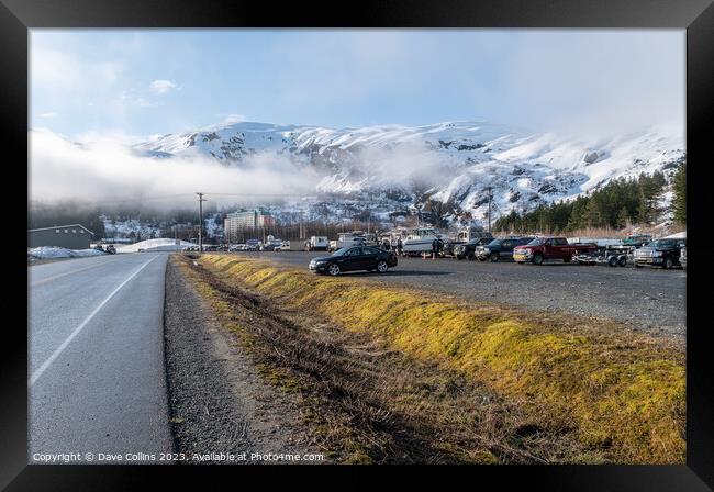 The main car and boat trailer parking area in Whittier with the  Begich Towers Condominium building and fog and snow mountains , Whittier, Alaska, USA Framed Print by Dave Collins