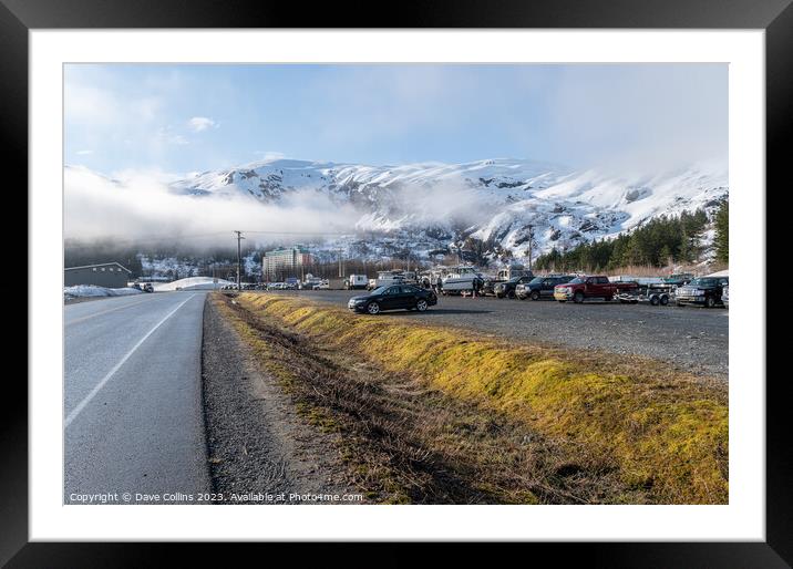 The main car and boat trailer parking area in Whittier with the  Begich Towers Condominium building and fog and snow mountains , Whittier, Alaska, USA Framed Mounted Print by Dave Collins