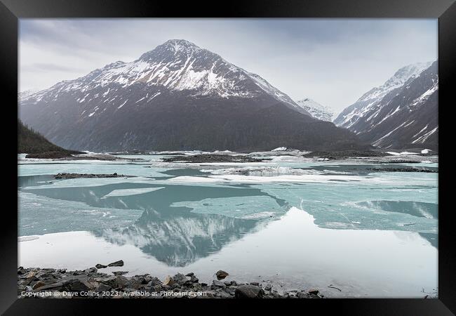 Snow covered mountains reflected between the ice sheets in Valdez Glacier Lake, Valdez, Alaska, USA Framed Print by Dave Collins