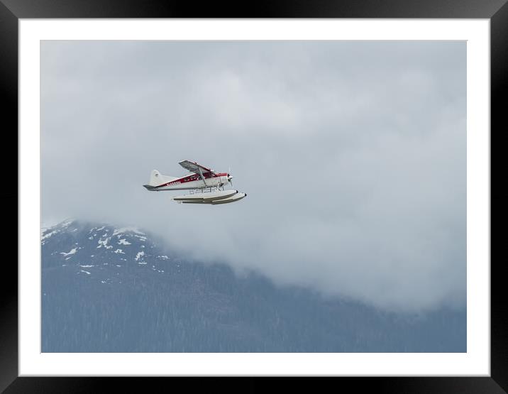 DeHavilland DHC-2 Float Plane Flying low past cloud covered mountains Alaska, USA Framed Mounted Print by Dave Collins